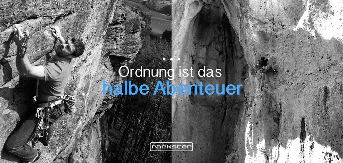 Kletterer greift nach einem Griff am Fels